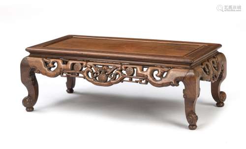 A CARVED APRON LOW TABLE