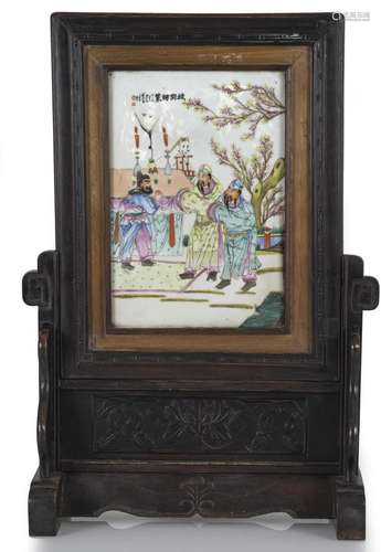 A WOODEN TABLE SCREEN WITH A POLYCHROME PORCELAIN PANEL WITH...