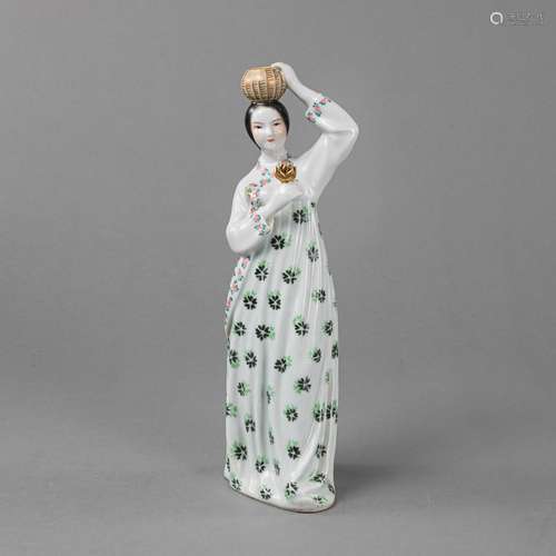 A POLYCHROME PORCELAIN FIGURE OF A YOUNG WOMAN