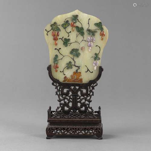 A STONE-INLAID JADE TABLE SCREEN ON A CARVED WOOD STAND