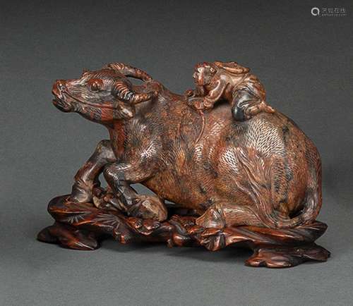 A CARVED SOAPSTONE RECUMBENT BUFFALOE WITH HERD BOY AND CARV...