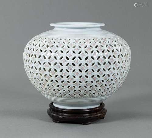 A CELADON-GLAZED PORCELAIN VASE WITH PIERCED SHIPPO PATTERN ...