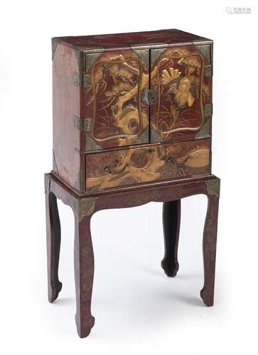 A LACQUER CABINET ON A STAND