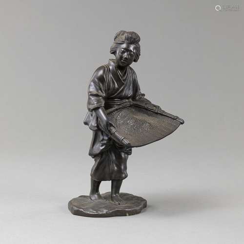 BRONZE FEMALE FARMER WITH DARK PATINA HOLING A BAMBOO SIEVE