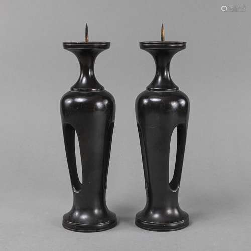 A PAIR OF BRONZE CANDLESTICKS