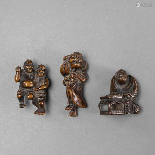 A GROUP OF THREE CARVED WOODEN NETSUKE INCULDING TWO SUMO WR...