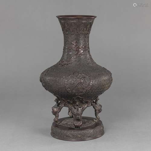 A FOUR-FOOTED BRONZE VASE WITH STYLIZED CLOUDS IN RELIEF