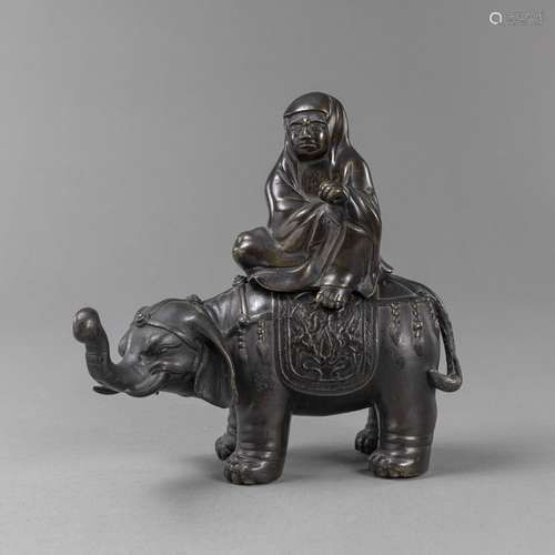 A BRONZE FIGURE OF DARUMA RIDING AN ELEPHANT