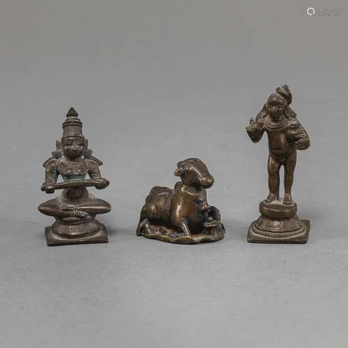 THREE BRONZE FIGURINES OF A SEATED DIVINITY, NANDI AND KRISH...