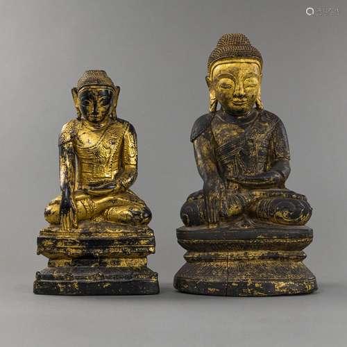 TWO SEATED WOODEN FIGURES OF BUDDHA ON A BASE, PARTLY GILDED...