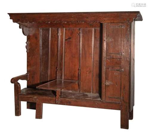 A curious English Elizabethan style oak bench cupboard, with...