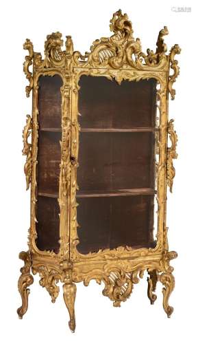A richly carved and giltwood Venetian Rococo style display c...
