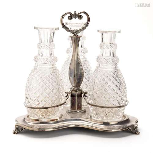 A Dutch silver holder with three cut glass flasks