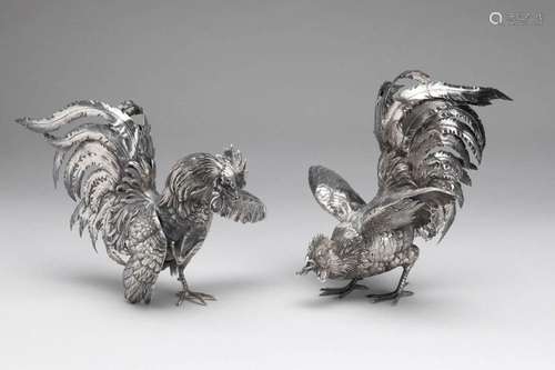 A pair of silver roosters