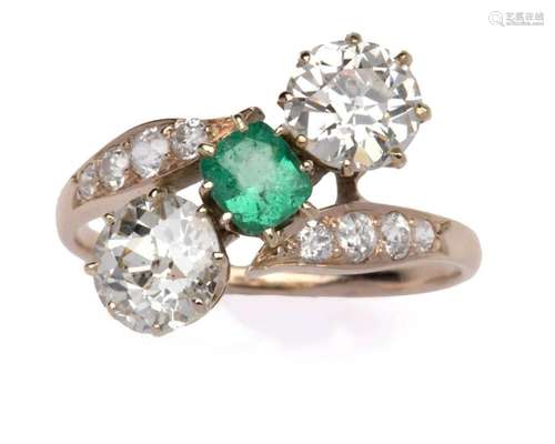 An emerald and diamond cross-over ring