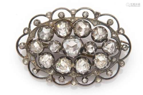 An antique 14k gold and silver diamond brooch