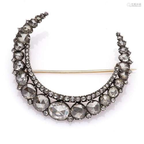 An antique diamond crescent brooch