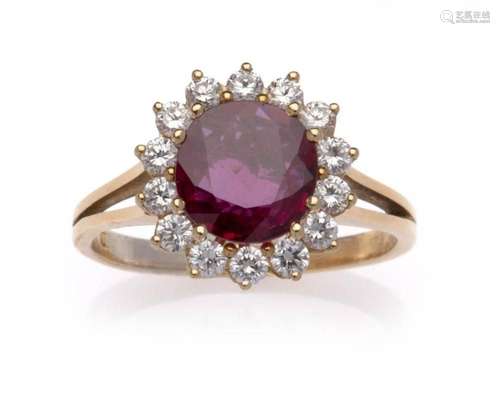 An 18k gold ruby and diamond cluster ring