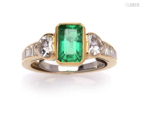 An 18k gold emerald and diamond ring