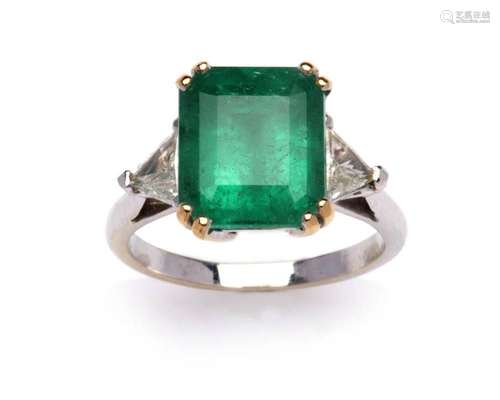 An 18k gold emerald and diamond ring