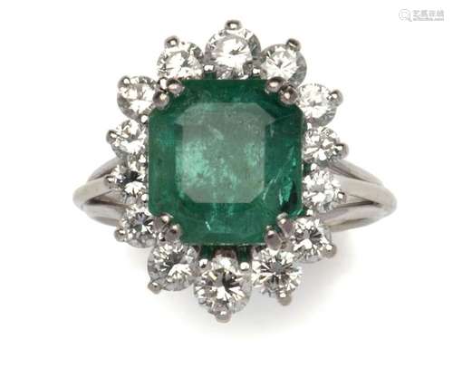 A 14k white gold emerald and diamond dress ring