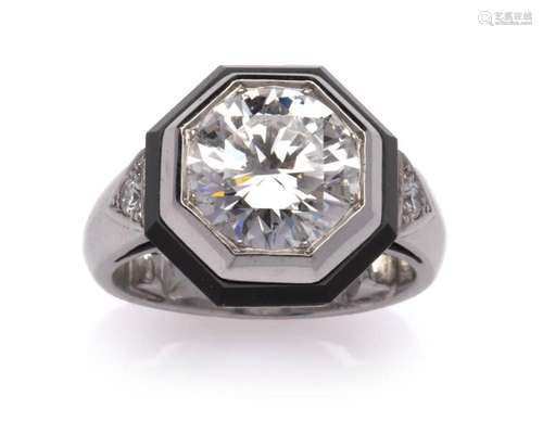 An 18k white gold onyx and diamond ring