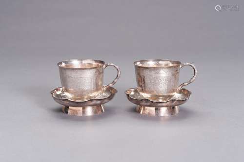 A PAIR OF SILVER CUPS WITH MATCHING SAUCERS