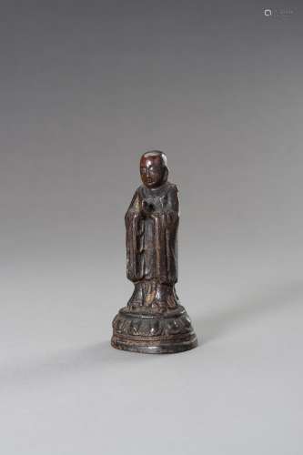 A MINIATURE BRONZE FIGURE OF A MONK, EARLY QING DYNASTY