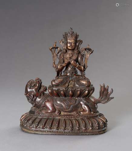 A BRONZE GUANYIN AND LION GROUP, 20TH CENTURY