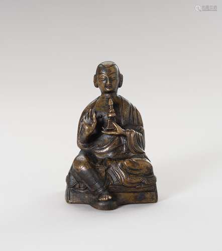 A BRONZE FIGURE OF A LAMA