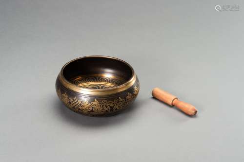 A PARCEL GILT BRONZE SINGING BOWL