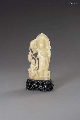 A CARVED SOAPSTONE FIGURE OF GUANYIN AND CHILD, LATE QING