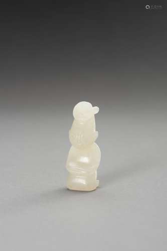 A PALE CELADON JADE FIGURE OF A KNEELING MAN