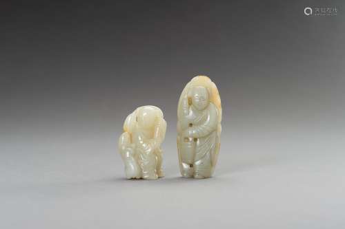 † TWO CELADON AND RUSSET JADE FIGURINES, 1900s