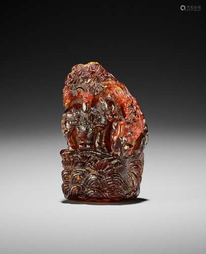 A CARVED AMBER 'WARRIORS' PENDANT, EARLY QING DYNA...