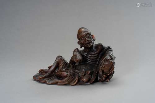 A WOODEN FIGURE OF A LUOHAN, LATE QING DYNASTY TO REPUBLIC P...
