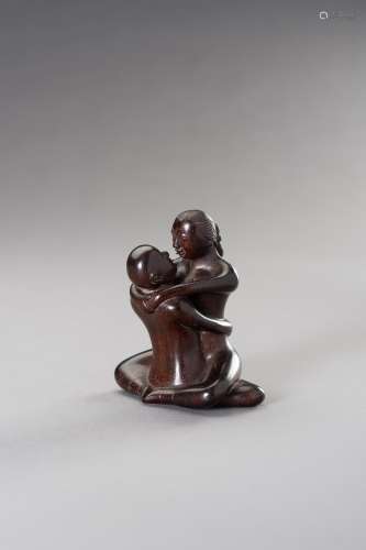 † A ZITAN WOOD FIGURE OF A COUPLE IN EROTIC EMBRACE
