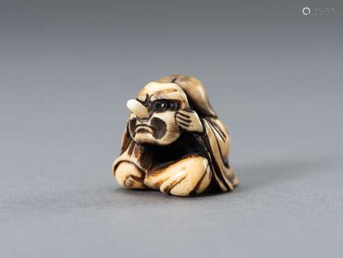 Ɏ MASAMITSU: A MARINE IVORY NETSUKE OF OKAME HOLDING A TENGU...