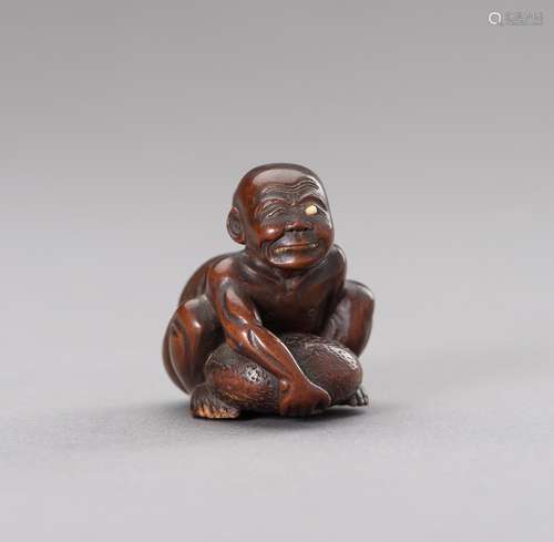 A WOOD NETSUKE OF A BLIND STONE LIFTER