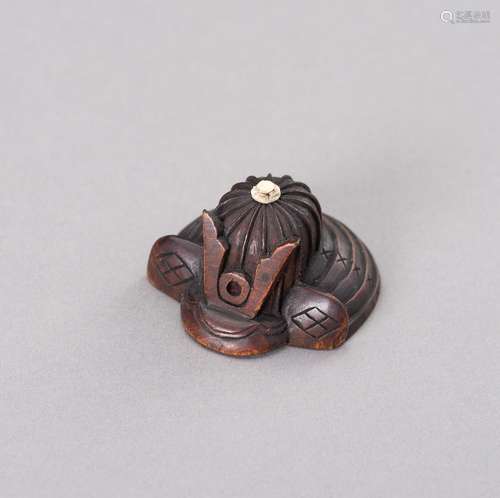 A WOOD NETSUKE OF A KABUTO