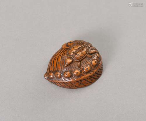 A WOOD NETSUKE OF A MINOGAME ON AN OUTSIZED AWABI