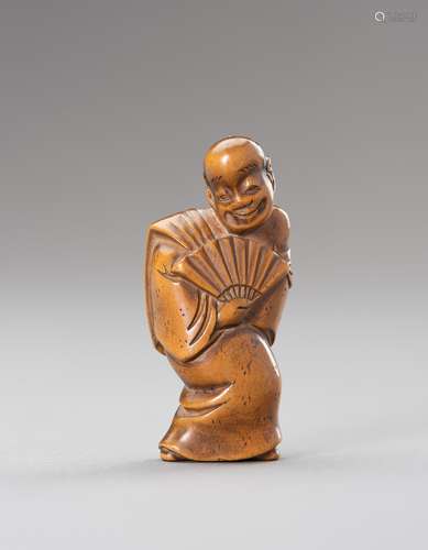 A WOOD NETSUKE OF AN ACTOR WITH FAN