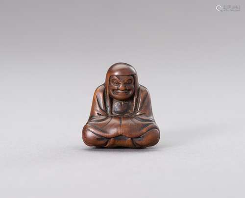 A WOOD NETSUKE OF DARUMA