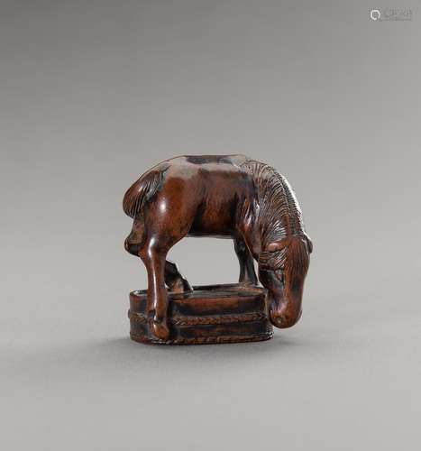 CHOZAN: A BOXWOOD NETSUKE OF A GRAZING HORSE