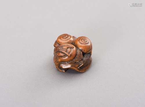 MITSUHIRO: A WOOD NETSUKE OF THREE SNAILS ON A SHIMEJI MUSHR...