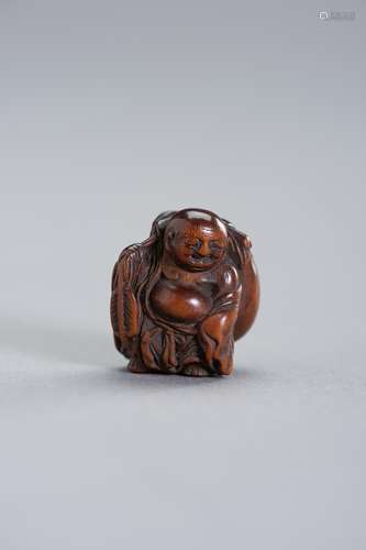 A RARE MINIATURE WOOD NETSUKE OF HOTEI