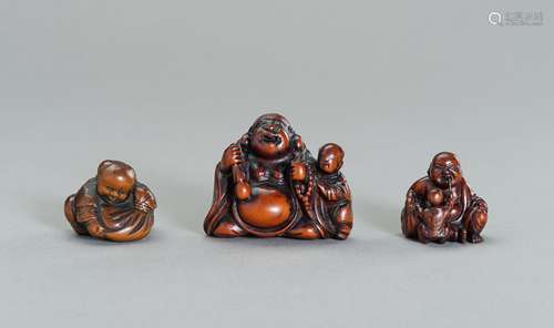 A GROUP OF THREE WOOD NETSUKE OF HOTEI AND KARAKO