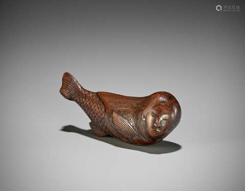 AN UNUSUAL WOOD NETSUKE OF A SWIMMING NINGYO (MERMAID)