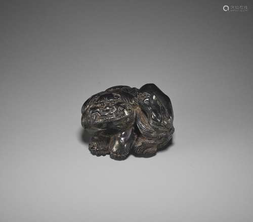 KOKEI: A RARE EBONY WOOD NETSUKE OF A SHISHI SCRATCHING HIS ...