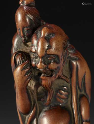 A TALL EARLY EDO SCHOOL WOOD NETSUKE OF IKKAKU SENNIN CARRYI...